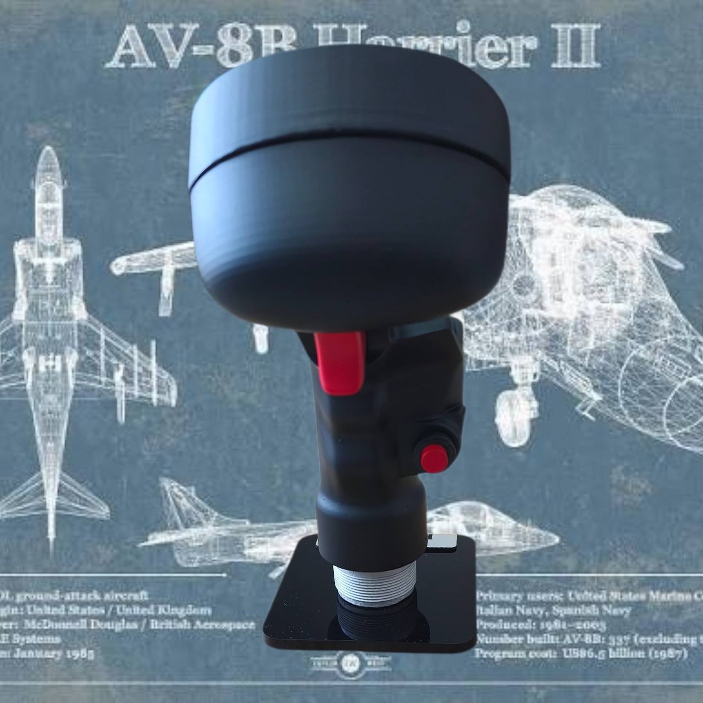 Black and red handheld device with 'AV-8B Harrier II' text on a blue background with airplane illustrations.