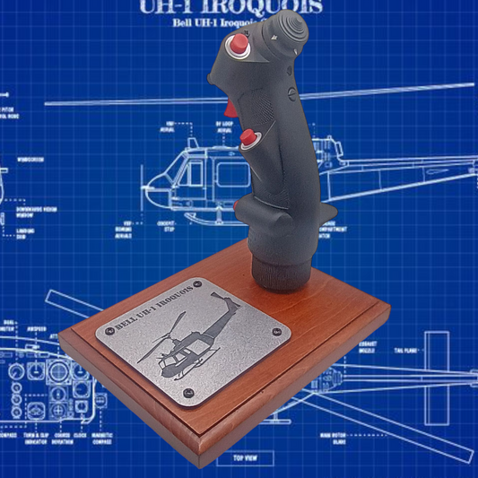 Left side of UH-1 helicopter cyclic stick on wooden display base.