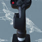 Black joystick with red button on a stand against a technical drawing background