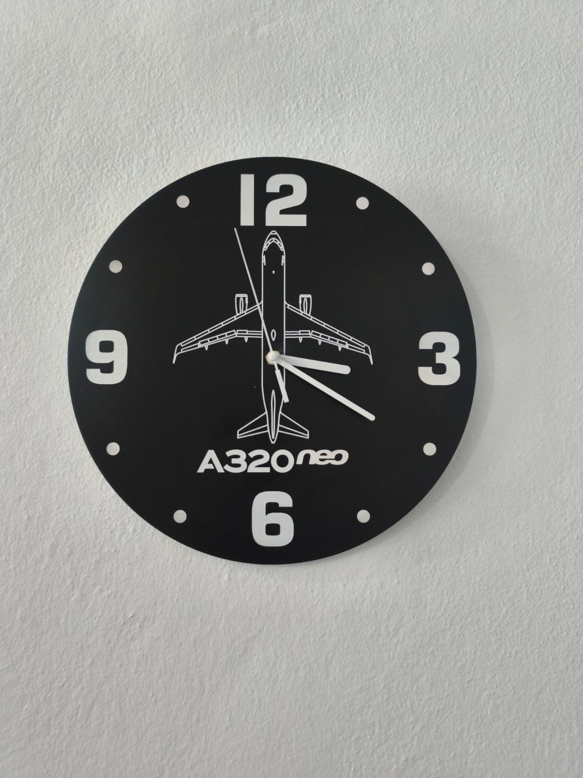 Wall clock with airplane design and 'A320neo' text on a gray background