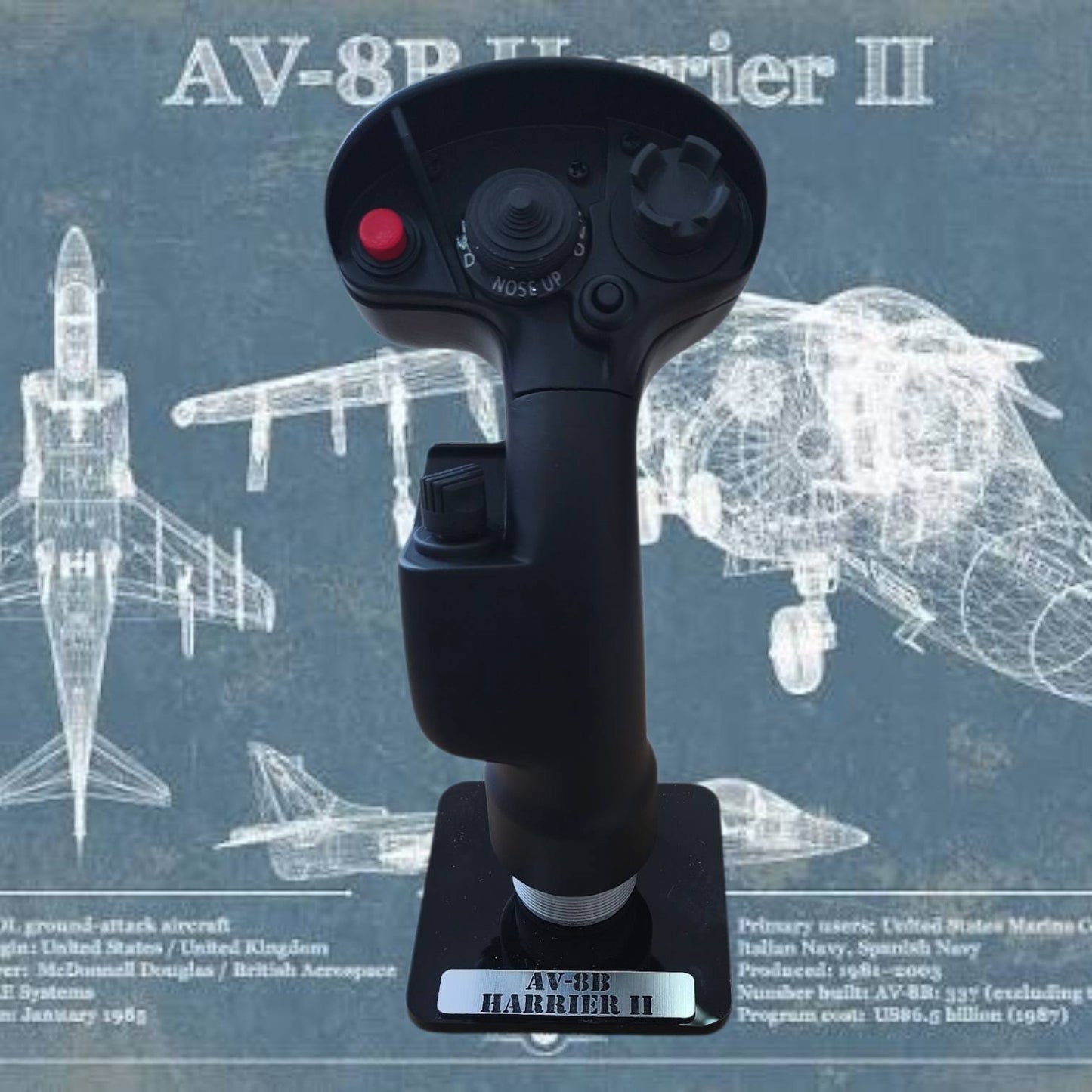 Model of an AV-8B Harrier II joystick with technical drawings of the aircraft in the background.