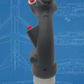 Black handheld tool with red buttons on a blue technical drawing background
